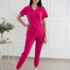 A woman in pink scrubs posing for the camera